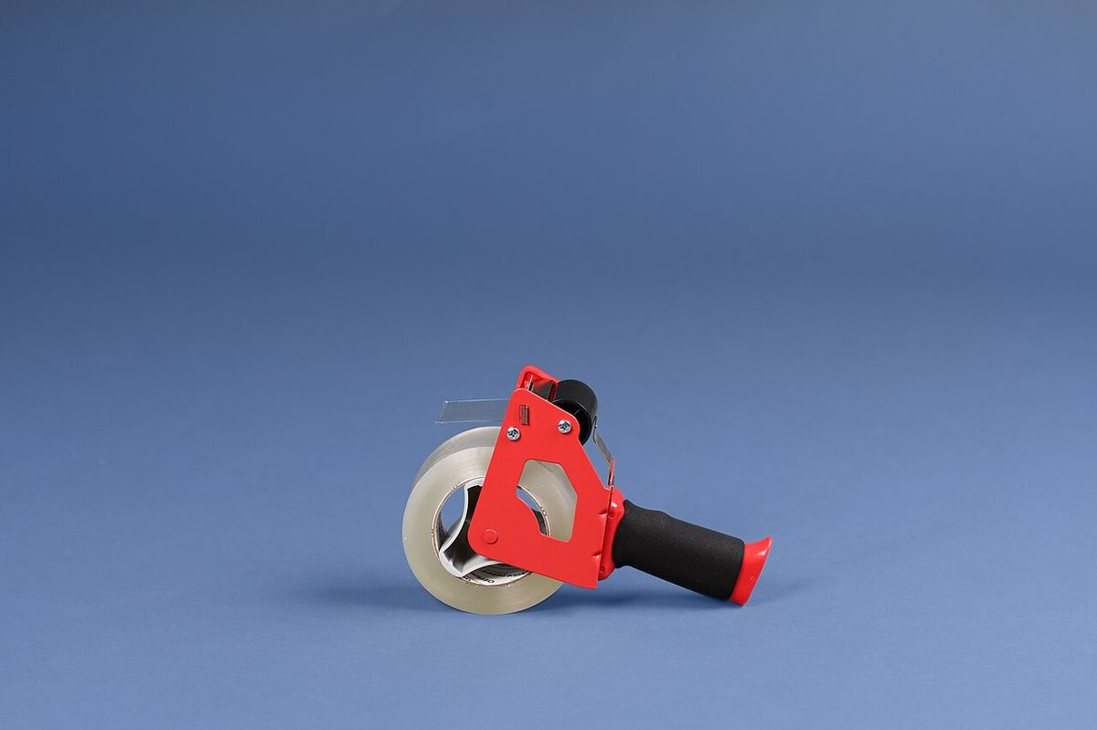 Roll of clear packing tape on an industrial tape gun dispenser